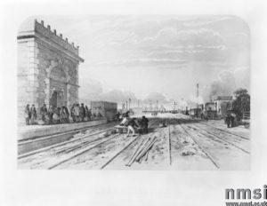 A lithograph of Crewe station, Cheshire, 1848. This was one of fifteen scenes of the London & North Western Railway produced by the artist and lithographer A F Tait, and published by Bradshaw and Blacklock in Manchester. Before the coming of the railways Crewe was a small hamlet. However, in the 1830s it became the junction of the Chester & Crewe Railway, Manchester & Birmingham Railway, and the Grand Junction Railway. The hamlet quickly expanded and the surrounding land was used as the site of its locomotive and carriage works.